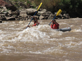 Whitewater inflatable kayaking through Canyonlands National Park